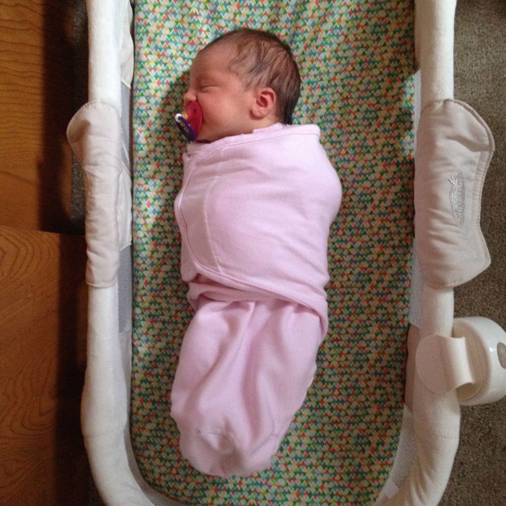 swaddled baby sleep in crib 