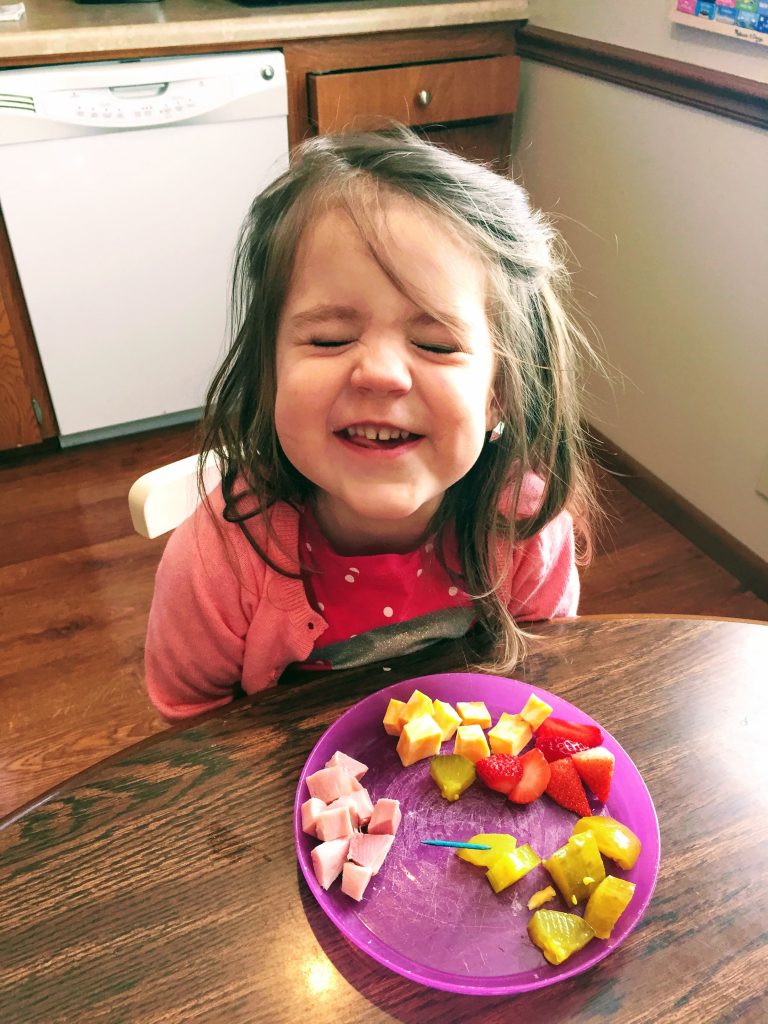 toddler eating veggies happily